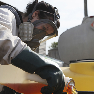 Worker with PPE Pouring Liquid